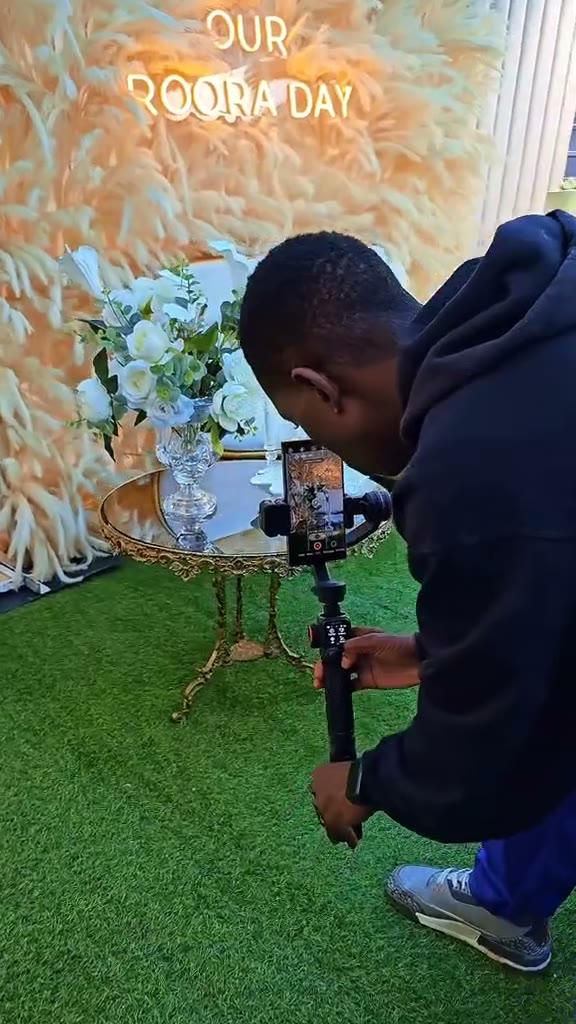 Still from the video: Capturing the decor before guests arrive: tables, florals and the backdrop, shot on gimbal.